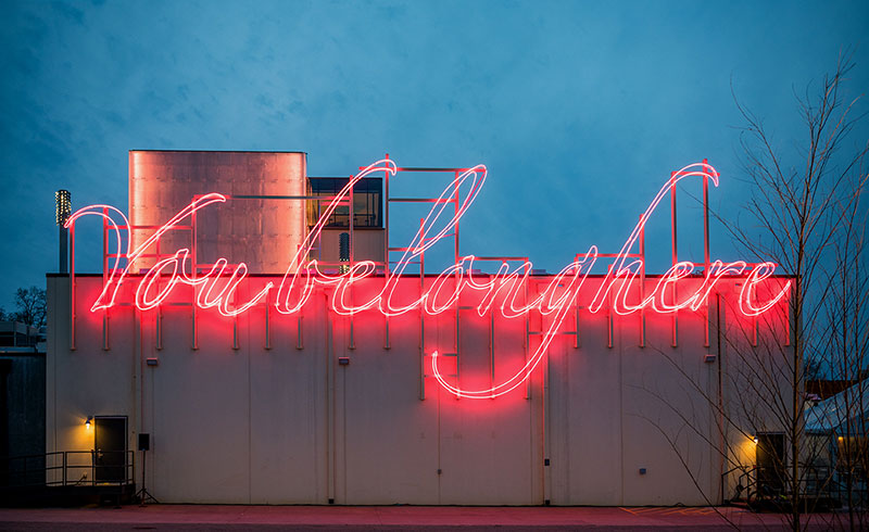 You Belong Here by Tavares Strachan, pink neon script on the Momentary's east wall in Bentonville